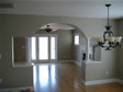 Beautiful view of the arched opening between the family room and dining room in this modular home